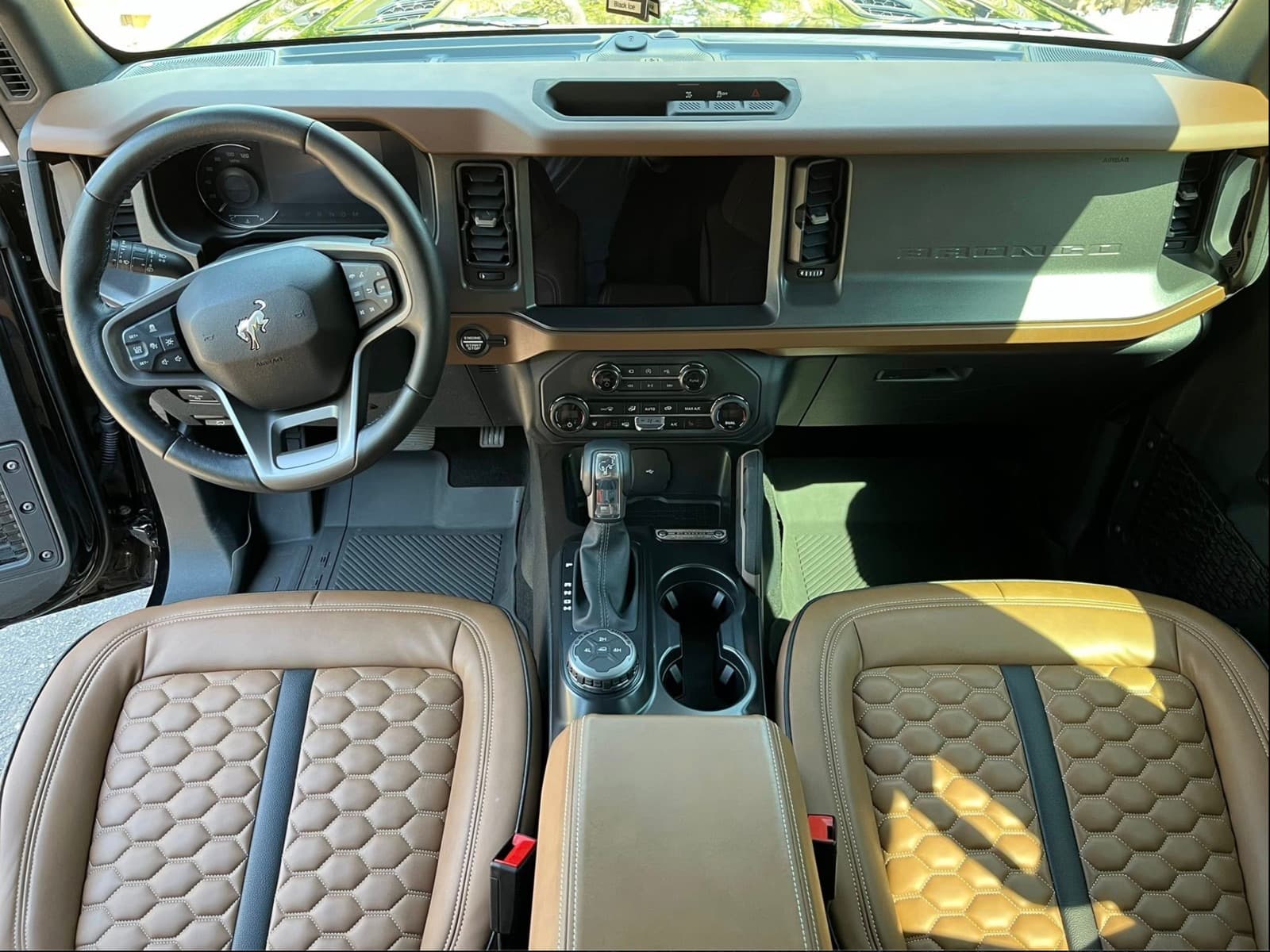 Ford Bronco cognac leather interior — clean dashboard and honeycomb-stitched seats after a full interior detail.